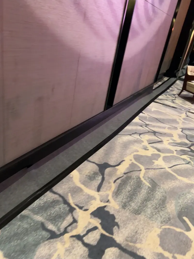 Cable run tucked along the edge of the carpet, out of sight