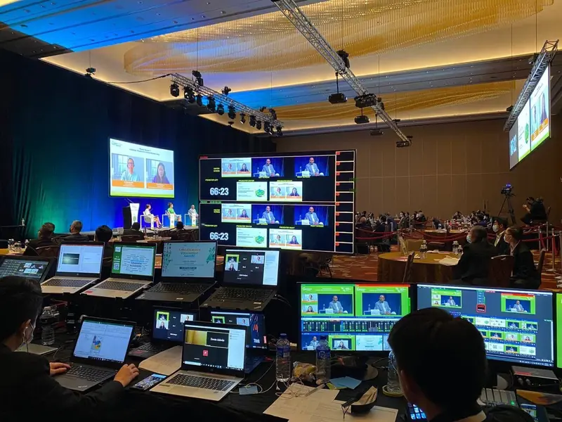 Vision desk with multiview monitors and laptops at a ballroom conference
