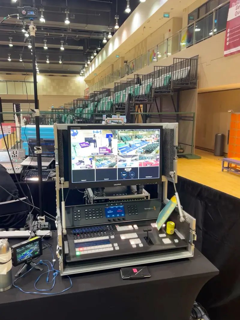 Vision mixer and monitor in a flight case beside a sports hall court